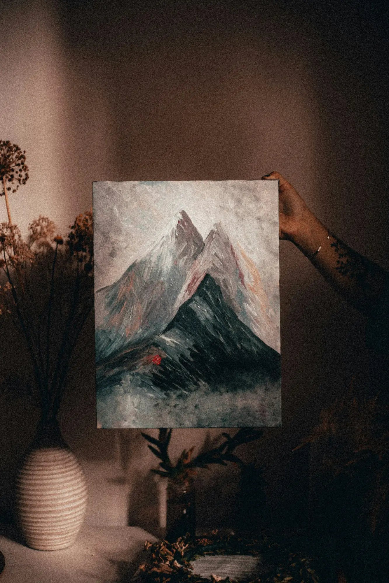 Painting of a snow-capped mountain peak in modern memory design frame against moody sky