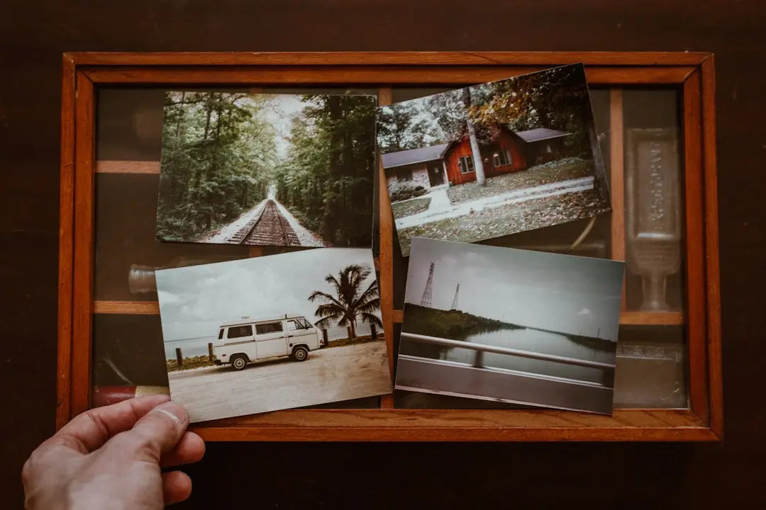 Wooden frame with four vintage photographs reflecting modern memory design elegance.