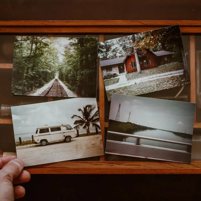 Wooden frame with four vintage photographs reflecting modern memory design elegance.