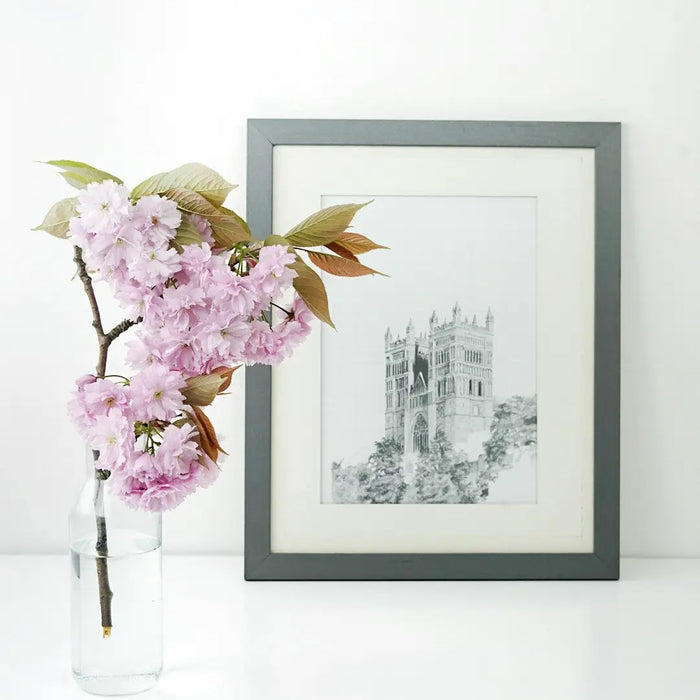 Framed cathedral sketch with cherry blossoms in a custom framing process at frame shop.