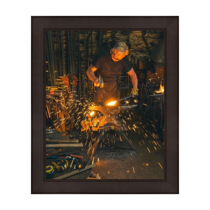 Blacksmith creating sparks while forging metal, featured in a 24x30 picture frame