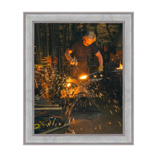 Blacksmith forging metal with sparks, ideal for 24x30 picture frame display