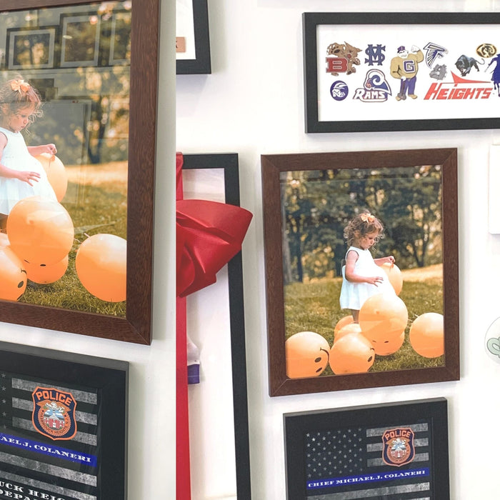 Wall hanging of framed photographs and memorabilia in Brown Wood Picture Frame