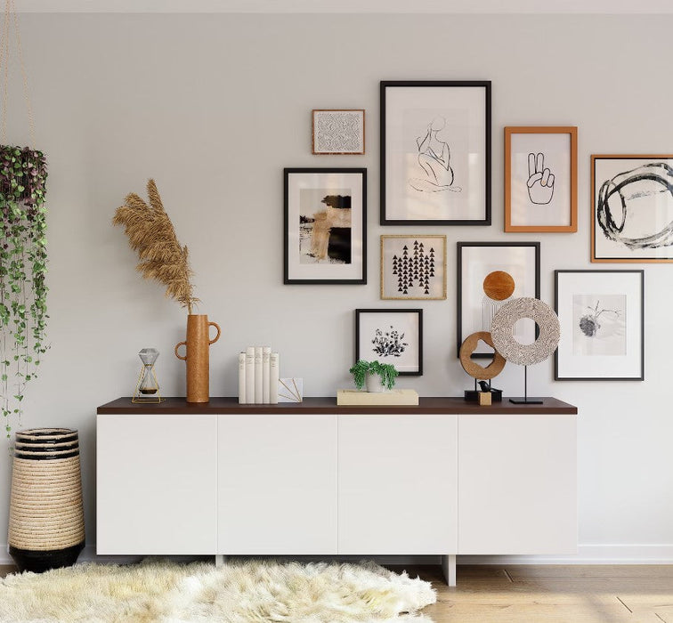 Gallery wall with 9x37 picture frames and artworks above a white cabinet