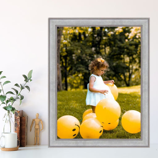 a little girl standing in front of a bunch of yellow balloons