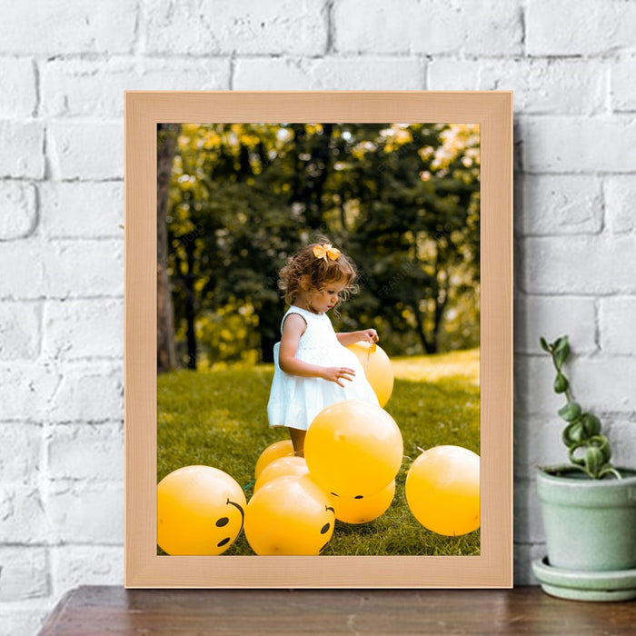 a picture of a little girl surrounded by yellow balloons